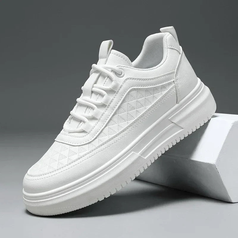 White sneaker with textured sole and geometric pattern, modern casual footwear on gray background