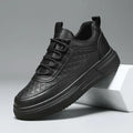 Black men's sneaker with textured geometric pattern and thick sole, side view