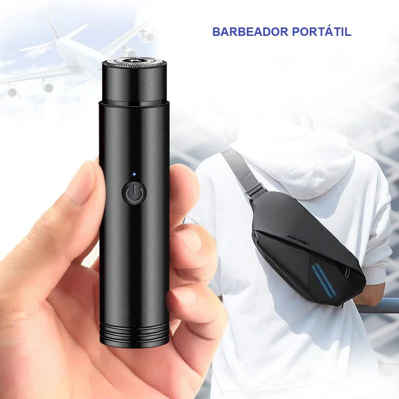 Hand holding a black portable rechargeable electric shaver with power button, travel setting